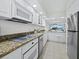 Updated kitchen featuring granite countertops, modern appliances, and an open layout at 1095 Gulf Of Mexico Dr # 503, Longboat Key, FL 34228
