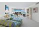 Well-lit living room featuring a sofa, chairs, carpeted floors, and sliding glass doors with water views at 1095 Gulf Of Mexico Dr # 503, Longboat Key, FL 34228