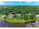 Aerial shot of home's backyard, lake, and lush landscaping at 1103 134Th E St, Bradenton, FL 34212