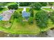 Aerial image of a home with a manicured lawn and screened pool, backing onto a picturesque lake at 1103 134Th E St, Bradenton, FL 34212