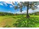 Large backyard overlooks a scenic pond with a bench for relaxing in nature at 1103 134Th E St, Bradenton, FL 34212