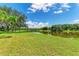 Beautiful backyard view of a pond on a sunny day at 1103 134Th E St, Bradenton, FL 34212