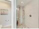 Modern shower with pebble floor, dual showerheads, and a small bench at 1103 134Th E St, Bradenton, FL 34212