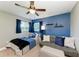 Stylishly designed bedroom features blue accent wall, modern furniture, and plush bedding at 1103 134Th E St, Bradenton, FL 34212