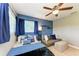Stylish bedroom with blue walls, comfy bed, a modern sofa, and plenty of natural light at 1103 134Th E St, Bradenton, FL 34212