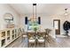 Charming dining area with wood table and decor, with accents of light and a large window at 1103 134Th E St, Bradenton, FL 34212