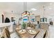 Spacious open-concept dining area leading to the living room and kitchen with decor and lighting at 1103 134Th E St, Bradenton, FL 34212
