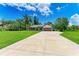 Charming home on a lush green lot with an expansive driveway and manicured lawn at 1103 134Th E St, Bradenton, FL 34212