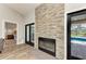 Beautiful fireplace feature with stone surround and black framed doors leading to the outdoor pool area at 1103 134Th E St, Bradenton, FL 34212