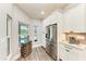 Bright kitchen area with white cabinets and stainless steel refrigerator at 1103 134Th E St, Bradenton, FL 34212
