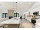 Bright and modern kitchen featuring white cabinets, marble island, stainless appliances, and fireplace at 1103 134Th E St, Bradenton, FL 34212