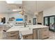 Open-concept kitchen with large island with seating, stainless steel appliances and view into living room at 1103 134Th E St, Bradenton, FL 34212
