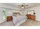 Cozy bedroom featuring a ceiling fan, bedside tables, and comfortable furnishings at 1103 134Th E St, Bradenton, FL 34212