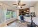 Spacious home office features a large window, built-in cabinets, and wood accent wall at 1103 134Th E St, Bradenton, FL 34212