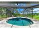Screened-in pool and spa feature updated tiling, inviting lounge chairs and peaceful view at 1103 134Th E St, Bradenton, FL 34212