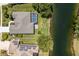 Aerial view of the home showcasing a screened-in patio and a lake view, along with solar panels on the roof at 12005 Summer Meadow Dr, Lakewood Ranch, FL 34202