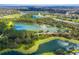 Breathtaking aerial shot of the community featuring a glistening lake and lush green vegetation; beautiful setting at 12005 Summer Meadow Dr, Lakewood Ranch, FL 34202