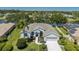 Stunning waterfront home featuring lush landscaping, a private dock, and solar panels for energy efficiency at 12005 Summer Meadow Dr, Lakewood Ranch, FL 34202