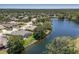 Waterfront homes showcasing screened-in patios, lush greenery, and large mature shade trees along tranquil waters at 12005 Summer Meadow Dr, Lakewood Ranch, FL 34202
