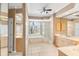 Bathroom featuring double sinks, a soaking tub, a walk-in shower, and ample natural light at 12005 Summer Meadow Dr, Lakewood Ranch, FL 34202