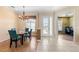 Inviting dining area with glass table, blue chairs, chandelier and tile flooring at 12005 Summer Meadow Dr, Lakewood Ranch, FL 34202