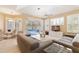 Combined living and dining area with views of the pool area through shuttered windows at 12005 Summer Meadow Dr, Lakewood Ranch, FL 34202
