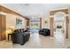 Inviting living room with tile floors, neutral walls, and sliding glass doors leading to the pool at 12005 Summer Meadow Dr, Lakewood Ranch, FL 34202