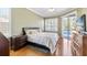 Main bedroom featuring hardwood floors, neutral wall paint, sliders to the pool, and ample natural light at 12005 Summer Meadow Dr, Lakewood Ranch, FL 34202