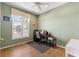Functional office space with natural light, desk, chair, and view of the yard at 12005 Summer Meadow Dr, Lakewood Ranch, FL 34202