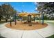 A covered community playground with fun activities for children, complete with benches for parents to relax and supervise at 12005 Summer Meadow Dr, Lakewood Ranch, FL 34202