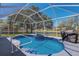 Screened-in pool area with a heated spa and tranquil backyard views at 12005 Summer Meadow Dr, Lakewood Ranch, FL 34202
