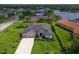 Aerial view of beautiful home, showcasing landscaping and neighborhood's proximity to a lake at 15451 27Th E Ct, Parrish, FL 34219