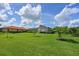 Vast backyard featuring manicured lawn and greenery, enclosed patio area and a tree line around the perimeter at 15451 27Th E Ct, Parrish, FL 34219