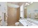 Full bathroom with a walk-in shower featuring tile, neutral paint, and a granite sink top at 15451 27Th E Ct, Parrish, FL 34219