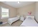 Cozy bedroom with twin beds, striped pillows, and nautical themed decor at 15451 27Th E Ct, Parrish, FL 34219