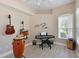 The bonus room provides a flexible space with a window, ceiling fan, and room for musical instruments at 15451 27Th E Ct, Parrish, FL 34219