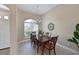 Formal dining room featuring wood table, elegant chandelier, and ample natural light at 15451 27Th E Ct, Parrish, FL 34219