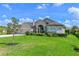 Charming single-story home featuring lush green lawn, manicured landscaping, and neutral color palette at 15451 27Th E Ct, Parrish, FL 34219