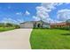Charming home with a well-manicured lawn, complemented by a spacious driveway and three-car garage at 15451 27Th E Ct, Parrish, FL 34219
