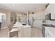 Modern kitchen with white cabinets, stainless steel appliances, and bar seating at 15451 27Th E Ct, Parrish, FL 34219