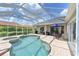 Inviting in-ground pool with an enclosure overlooking a meticulously landscaped backyard and patio area at 15451 27Th E Ct, Parrish, FL 34219