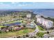 Panoramic aerial view featuring well-manicured golf course, ponds, condos, and waterfront in the distance at 1714 Fairway Trce, Palmetto, FL 34221