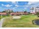Expansive golf course view featuring single-story homes, a sandy bunker, and manicured green with pond at 1714 Fairway Trce, Palmetto, FL 34221