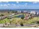 Sweeping aerial view showcasing the community's golf course, ponds, clubhouse, condos, and waterfront at 1714 Fairway Trce, Palmetto, FL 34221