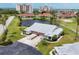 Stunning aerial view of home with pond, golf course, and nearby waterfront condos, offering serene Florida living at 1714 Fairway Trce, Palmetto, FL 34221
