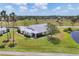 Stunning single story home with meticulous landscaping, an adjacent pond, and a wonderful golf course view at 1714 Fairway Trce, Palmetto, FL 34221