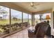 Sunroom with floor-to-ceiling windows providing gorgeous golf course views at 1714 Fairway Trce, Palmetto, FL 34221
