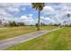 Scenic golf course view with palm trees and walking path at 1714 Fairway Trce, Palmetto, FL 34221