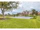 Community pond offering picturesque views of building and lush green surroundings at 1714 Fairway Trce, Palmetto, FL 34221