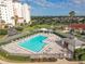 Beautiful community pool and sundeck with resort-style seating, surrounded by lush landscaping near the building at 1714 Fairway Trce, Palmetto, FL 34221